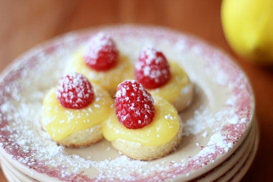 Lemon Curd and Raspberry Tea Cookies on a plate dusted with powdered sugar