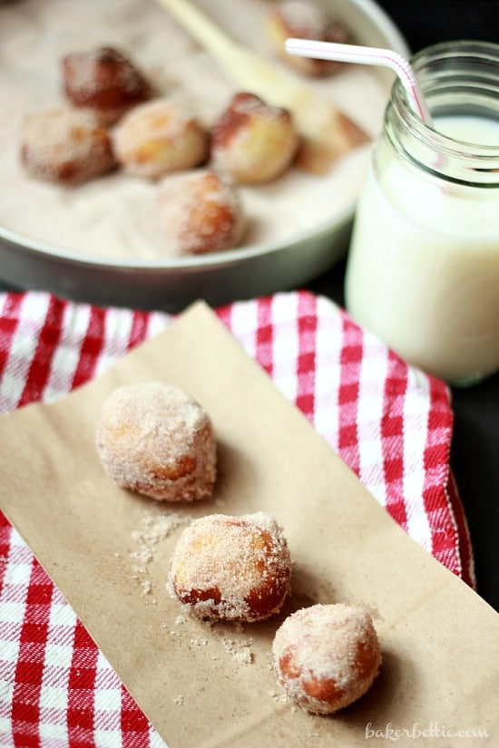 Chocolate Filled Mini Donuts on a napkin with a glass of milk