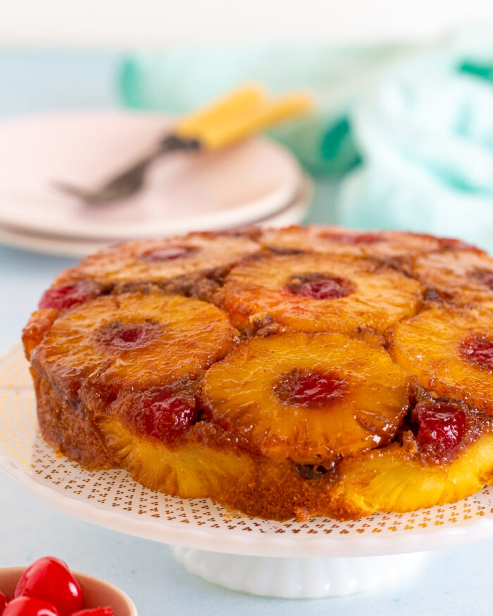 Pineapple Upside down cake with pecans on a cake stand