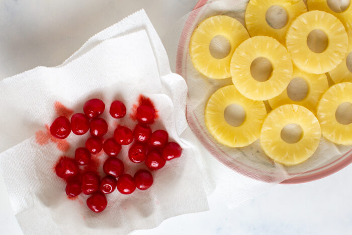 Pineapple rings and cherries drying on paper towels