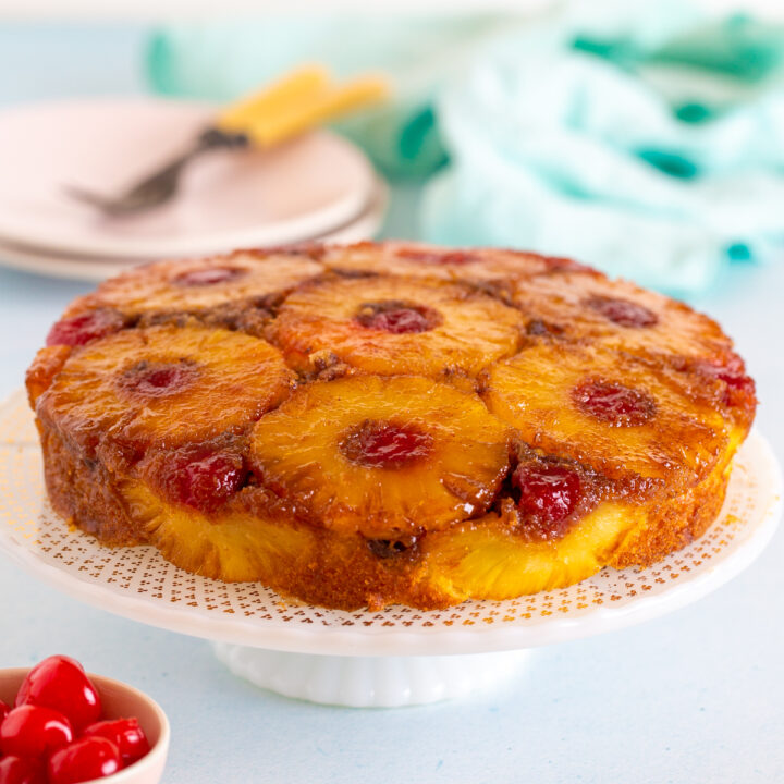 pineapple upside down cake on a cake stand