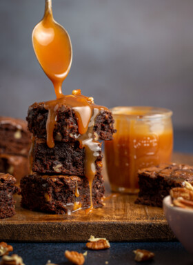 stack of brownies with caramel sauce drizzled on top