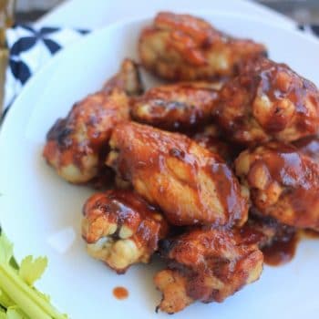 Oven Baked BBQ Buffalo Wings on a plate with celery