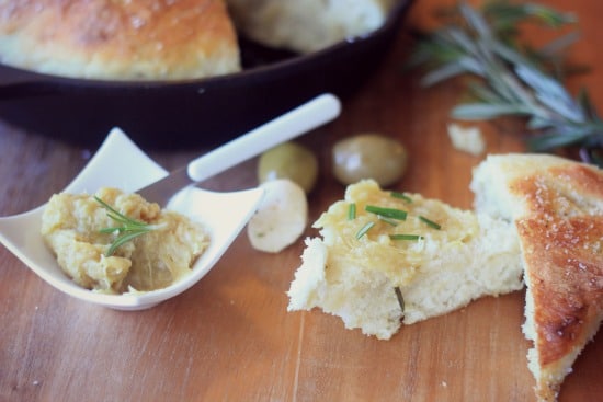 A piece of No-Knead Skillet Bread topped with garlic puree