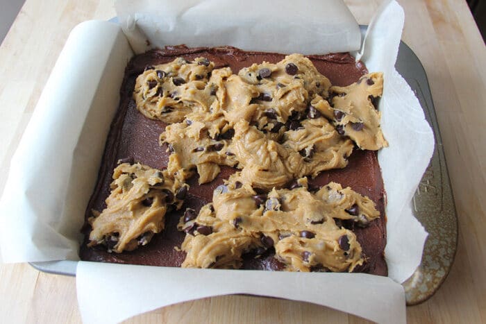 Dollops of chocolate chip cookie dough over the brownie batter before being spread out for the brookies