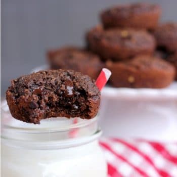 Chocolate Peanut Butter Oatmeal Brownie Bite perched on a glass of milk