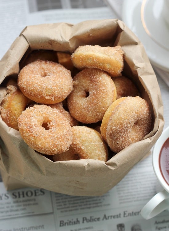 Cinnamon sugar mini baked donuts in a paper bag