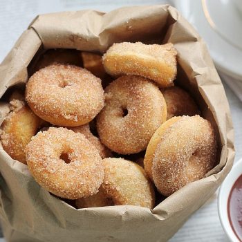 Cinnamon sugar mini baked donuts in a paper bag