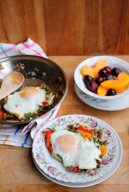 A serving of Roasted veggies in a skillet topped with an over-easy egg
