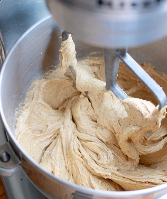 Butter and brown sugar in the bowl of a stand mixer after being creamed together for chocolate chip cookie cake