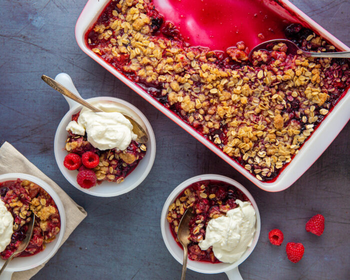 Triple Berry Crisp in bowls with ice cream