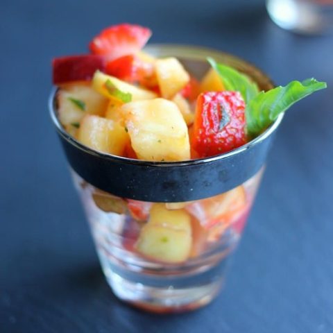 Cut up fruit in a dish with Herbs in a Lime and Honey sauce