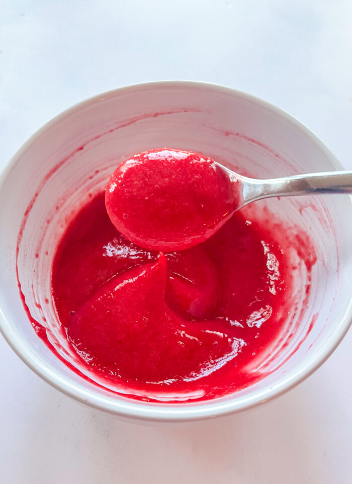 pureed raspberries after being pushed through s sieve