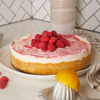 lemon raspberry cheesecake on a cake plate
