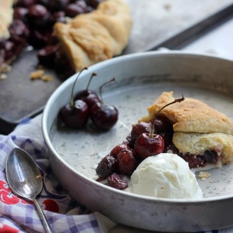 A slice of Free-Form Bourbon Soaked Cherry Pie with ice cream