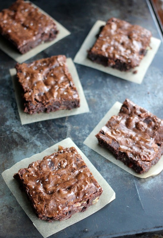 Ultimate Fudge Brownies squares cut up and on parchment paper