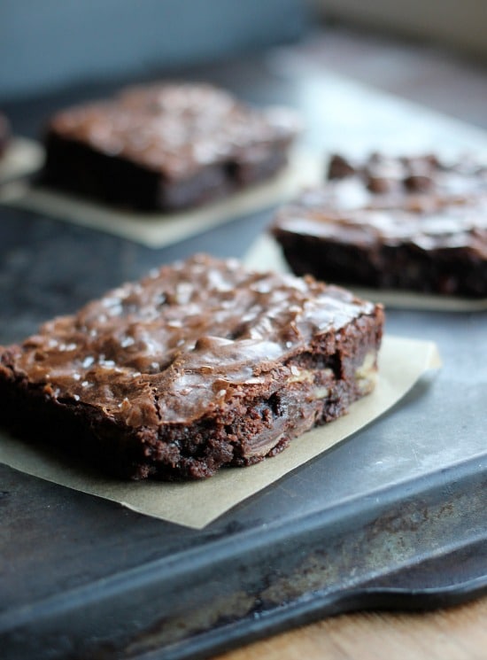 Ultimate Fudge Brownie squares on parchment paper