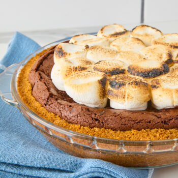 S'mores brownie pie in a pie plate topped with toasted marshmallows