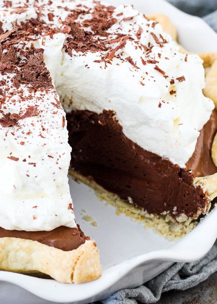 Chocolate french silk pie with a slice cut out of it