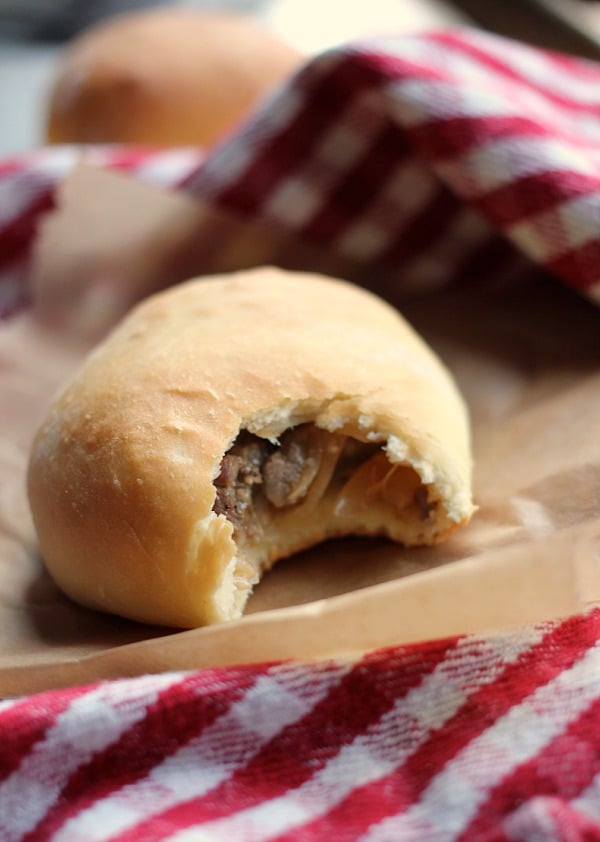 A Philly Cheesesteak Stuffed Bread Roll with a bite taken out