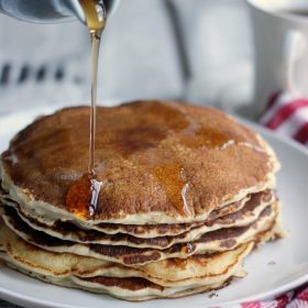 Stack of pancakes with syrup poured on