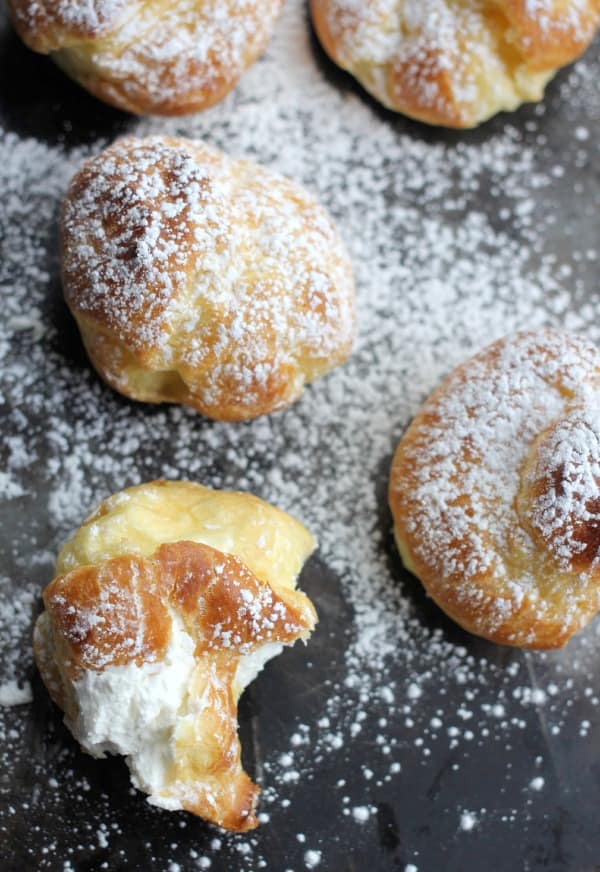 Classic Cream Puffs filled with cream sprinkled with powdered sugar