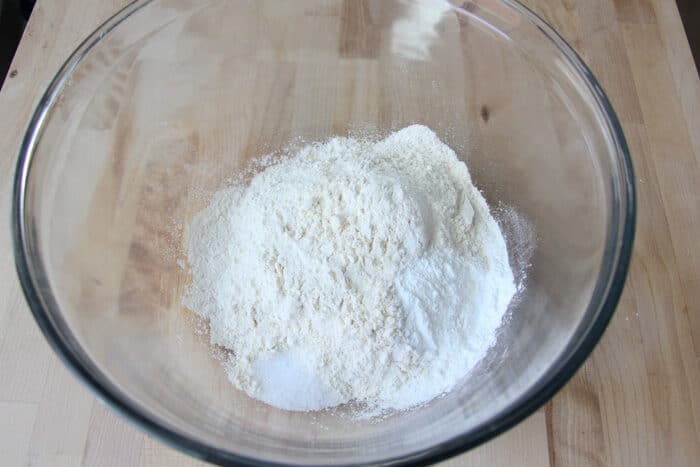 Dry ingredients (flour, salt, baking powder) in a bowl for drop biscuit dough.