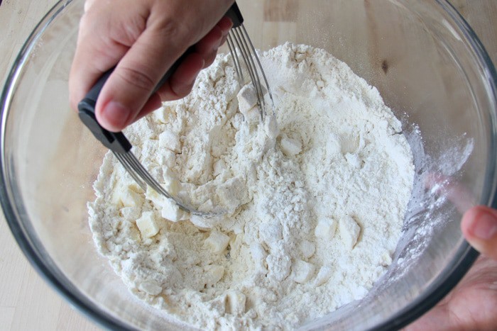 Cutting butter through the flour for drop biscuits.