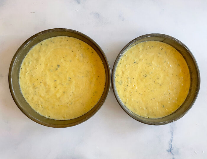 cake batter divided into 2 cake pans