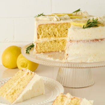 slices of lemon cake on plates with the cut cake behind them