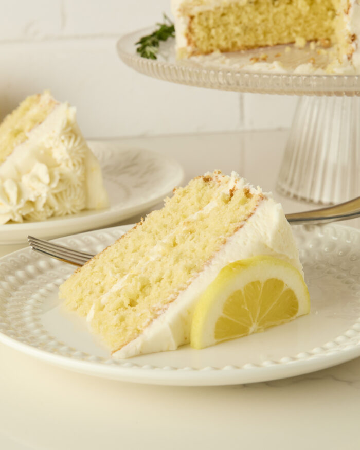a slice of lemon layer cake on a plate