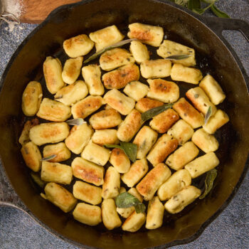 Parisian gnocchi in a cast iron with brown butter and fresh sage