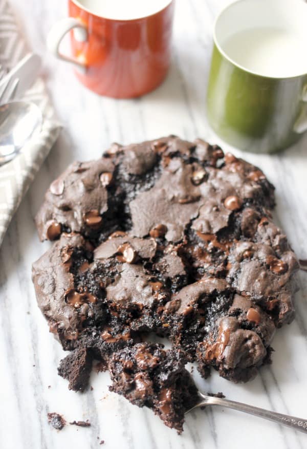 Huge Dark Chocolate Cookie with Espresso and Toasted Pecans with a spoon taking out a bite