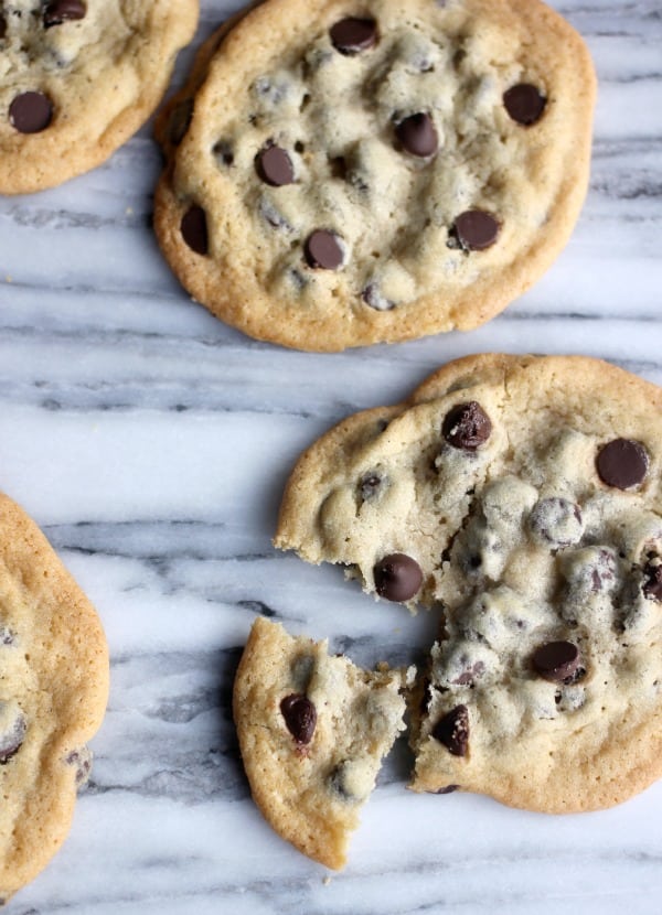 Thin and crispy chocolate chip cookies on a marble slab