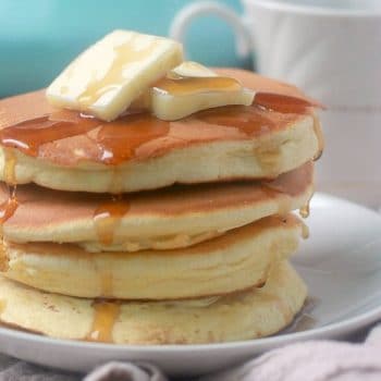 Stack of souffle pancakes with butter and maple syrup