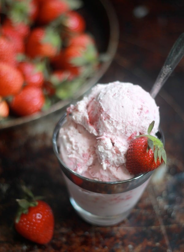 Roasted Strawberry Cheesecake Ice Cream in a dish garnished with fresh strawberries