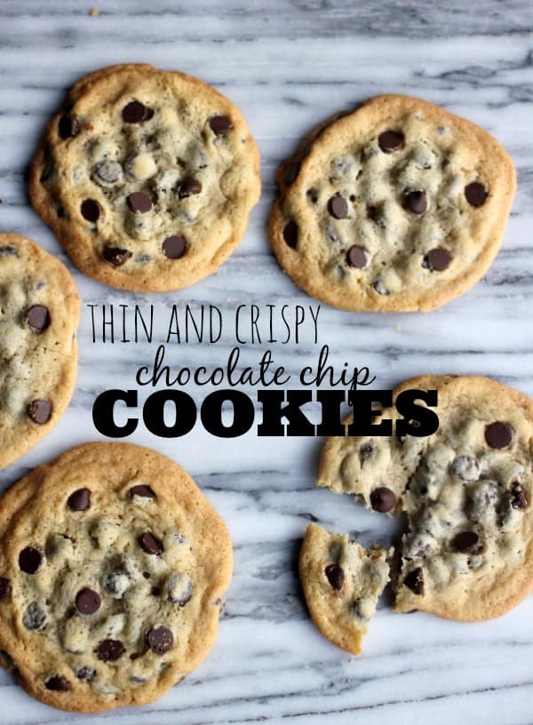 Thin and crispy chocolate chip cookies on a marble board with text
