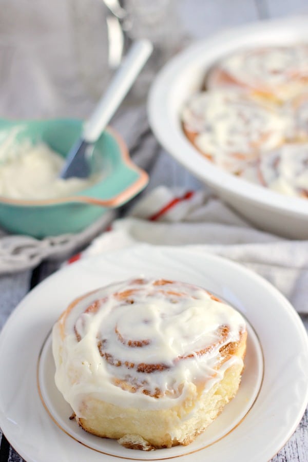 A Cinnamon Rolls with Cream Cheese Frosting on a plate