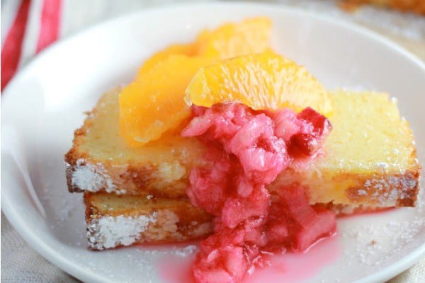 Slices of Tangerine Ricotta Pound Cake topped with slices of tangerine and rhubarb compote