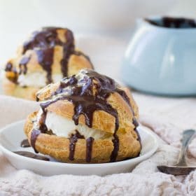 Profiterole filled with cream and topped with chocolate glaze