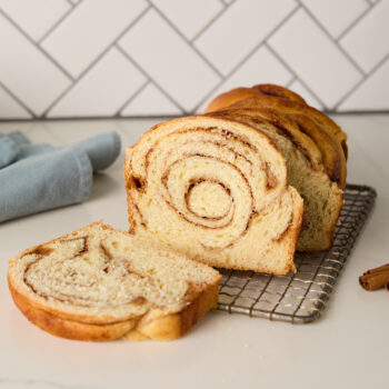 braided cinnamon loaf with a slice taken out