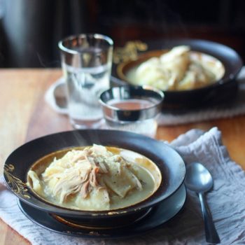 Chicken and Flat Dumplings in a soup bowl set at a table