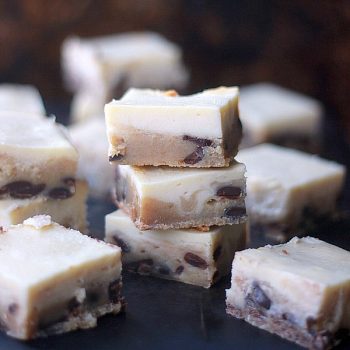 Cheesecake Cookie Dough Bars cut up into squares and stacked