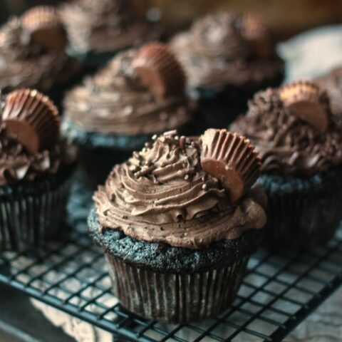 https://bakerbettie.com/wp-content/uploads/2014/10/dark-chocolate-cupcakes-peanut-butter-cups-480x480.jpg