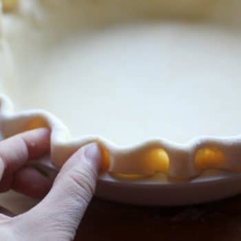 Pie crust being crimped with fingers