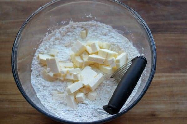 The instruction to "cut in fat" is a common instruction in baking recipes. The process of cutting in fat is very simple and a necessary skill for beautiful flaky and tender baked goods such as biscuits, scones, pie and pastry crusts. Butter pieces about to be "cut" into dry ingredients with pastry cutter