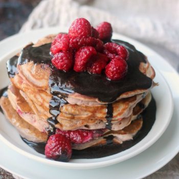 Raspberry Pancakes topped with Chocolate Glaze and fresh raspberries