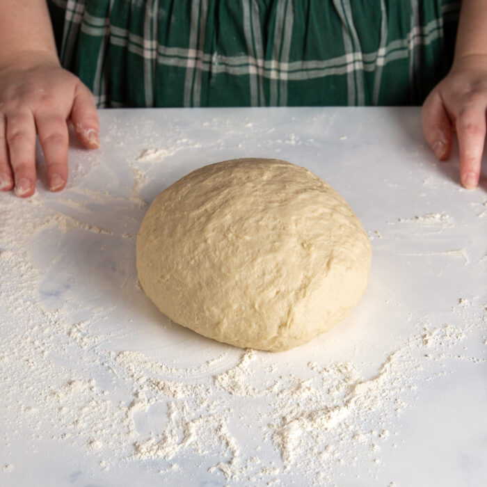 enriched dough formed into a ball on a countertop