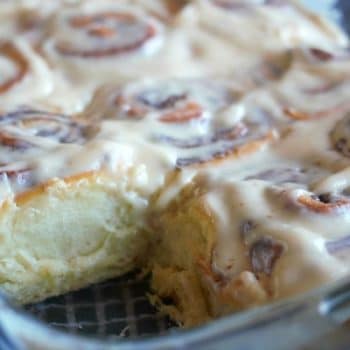 Gooey Cinnamon Rolls in a casserole dish slathered with cream cheese frosting