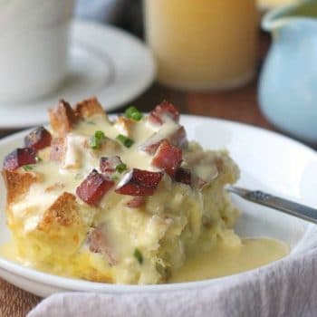 Eggs Benedict casserole on a plate topped with hollandaise sauce